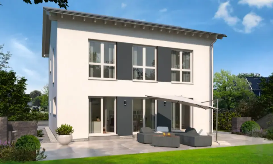 Moderne Stadtvilla mit Satteldach, großen Fenstern und einer gemütlichen Terrasse mit Lounge-Möbeln.